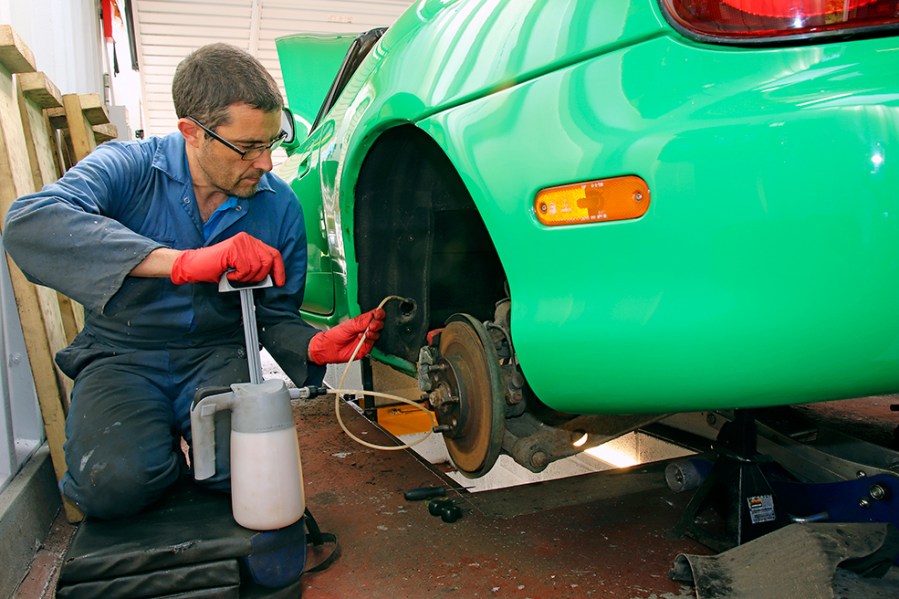 Applying a runny wax-based solution with a pump and long tube helps to spread it deep inside cavities such as sills and chassis legs. This hand pump is from Waxoyl.