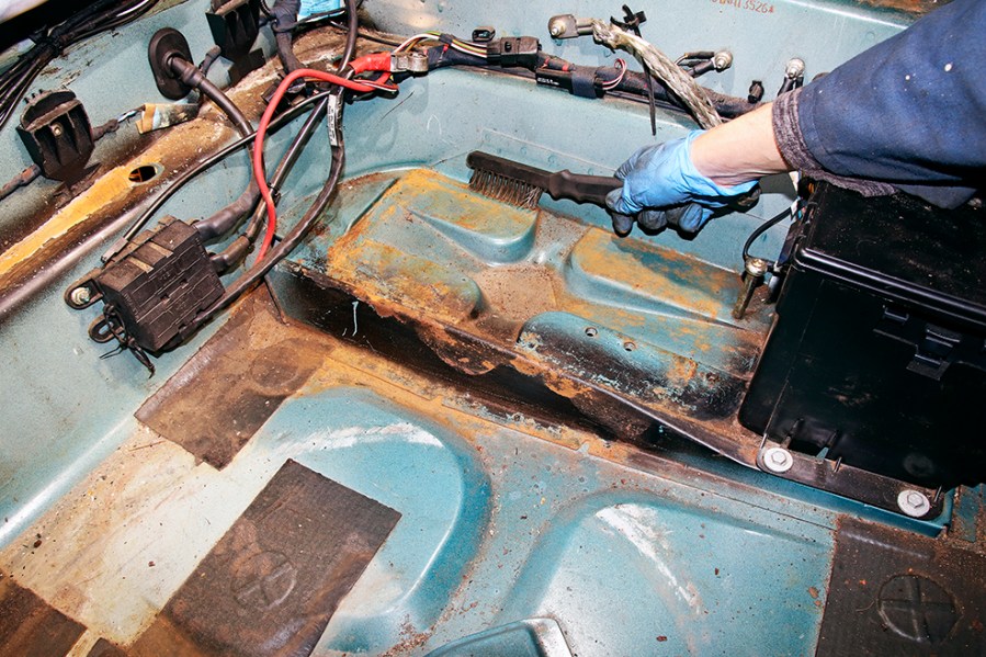 The vehicle’s battery doesn’t contribute towards the electrolysis process of corrosion. Only leaking battery acid and moisture around the battery can result in corrosion of the surrounding metalwork.