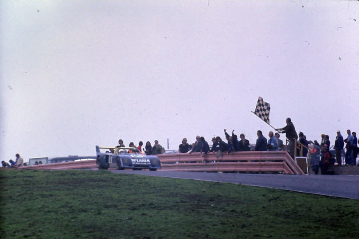 Checkered flag waving as car crosses the finish line at Knockhill in 1970s