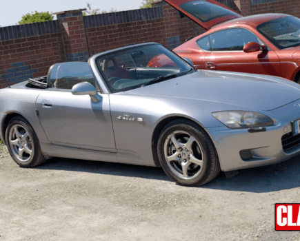 Honda S2000 parked in a car park with the roof down