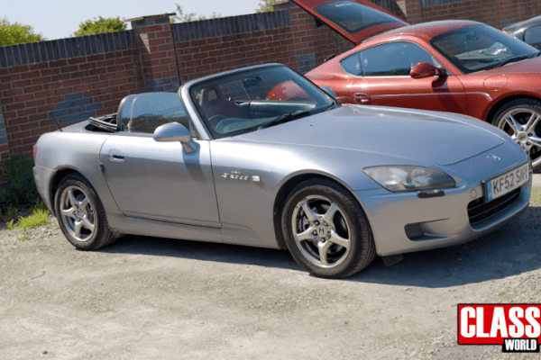 Honda S2000 parked in a car park with the roof down